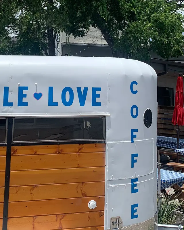 The Terrible Love mark painted on the side of their coffee trailer